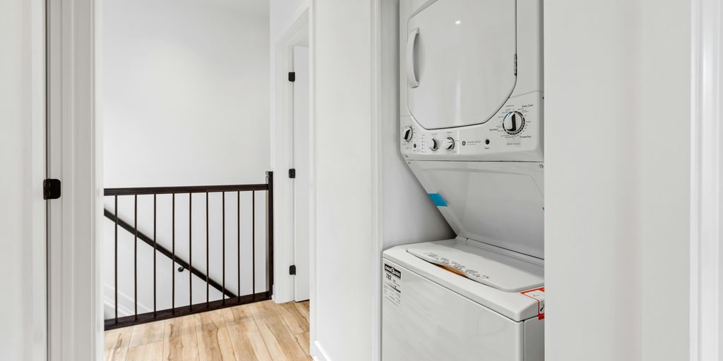 a white room with a mirror and a washer
